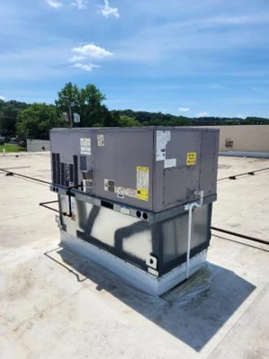 Packaged rooftop unit on the clean membrane roof of a multi-tenant retail center