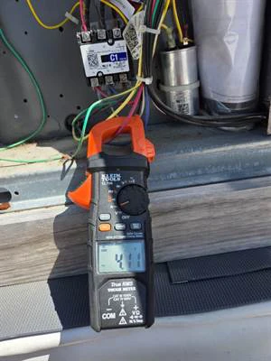 Clamp meter reading compressor amps after the repair